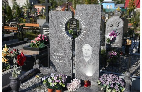 Двойной памятник из серого гранита с изображением солнца